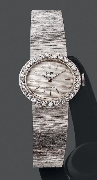 null Montre bracelet de dame en or gris 750 millièmes la montre de forme ovale le...