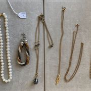 null Metal lot including: five necklaces, a bracelet, and a baroque cultured pearl...