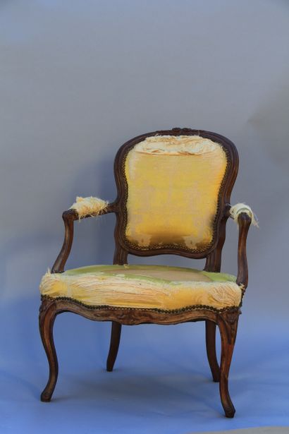 null Pair of beechwood armchairs, moulded, carved and stained, resting on cambered...