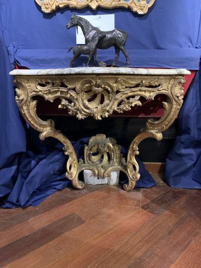 null 
A carved wooden console with asymmetrical openwork decoration of foliage, flowers...