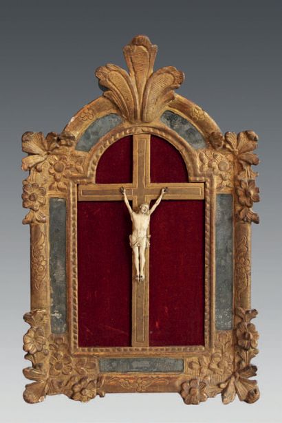 null A carved ivory crucifix, the frame with pediment and parecloses decorated with...