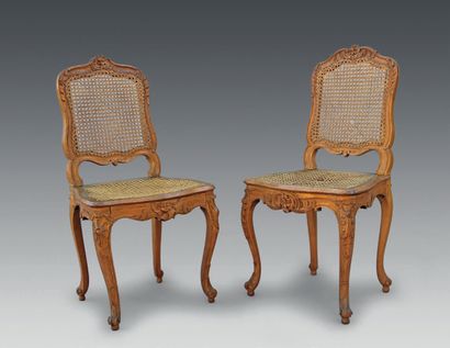 null 
Two carved beechwood caned chairs with flat backs and rocaille and foliage...
