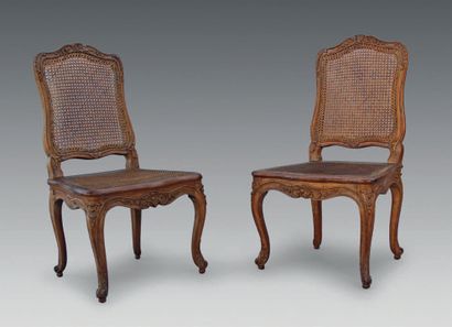null A pair of moulded and carved beechwood caned chairs, with flat back and rich...