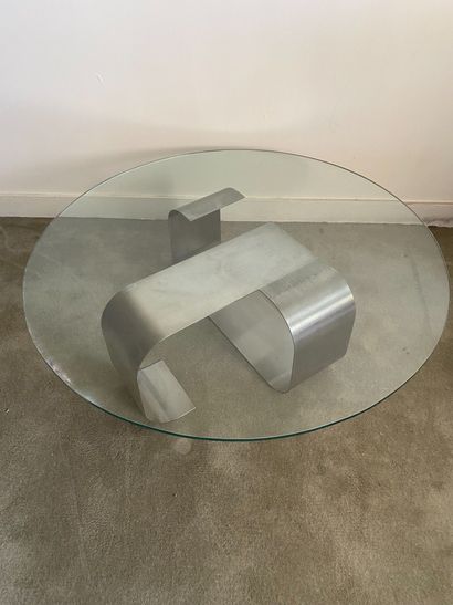 null Coffee table with brushed metal base and circular glass top. Work of the 70...