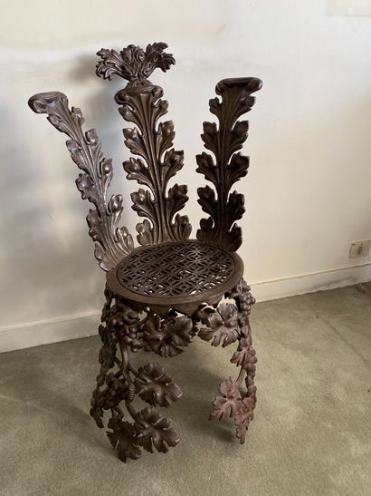null Curious chair in cast iron with stylized plant decoration.