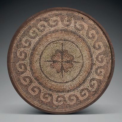 null Circular mosaic decorated in its center of a stylized flower, in a border of...