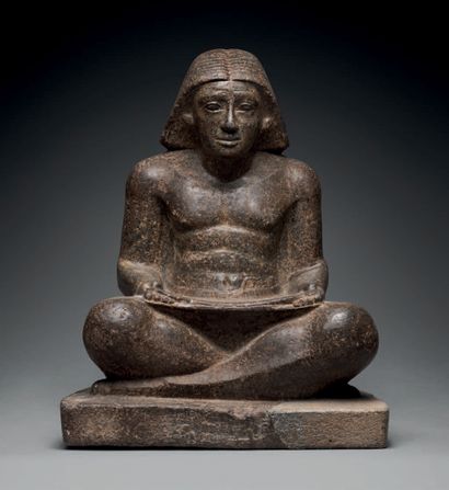 null Statue representing a character sitting cross-legged, holding a papyrus in his...