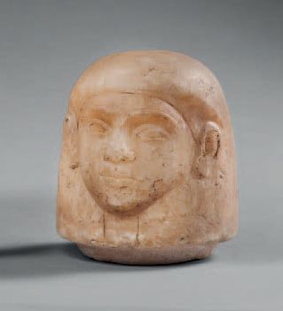 null Cap of a canopic vase representing the human-headed god Amset.
Alabaster. Visible...