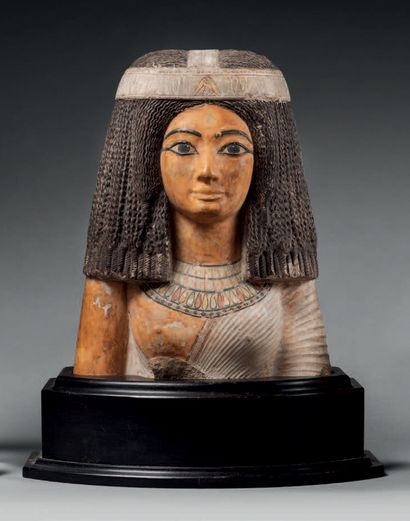 null Bust of a queen wearing a wig of braids and a pleated garment.
Limestone and...