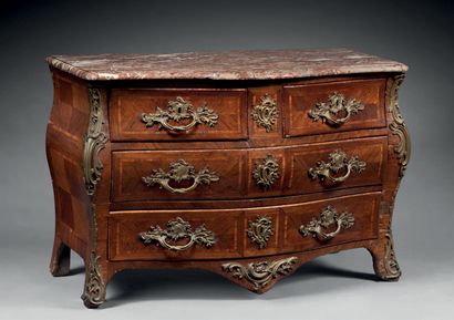 A violet wood chest of drawers, opening to...