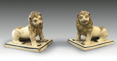 Rouen. Pair of earthenware lions sitting on rectangular bases, with ochre bottom,...