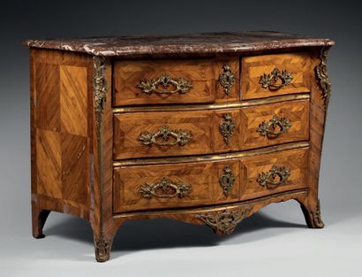 null A violet wood chest of drawers, opening to four drawers on three rows, the top...