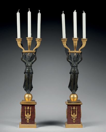 
Pair of Victory candelabras in patinated...