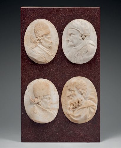Four carved marble medallions representing...