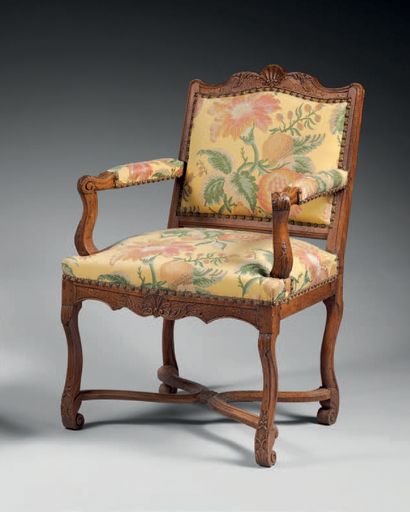 null Molded and carved walnut armchair with flat back and scroll legs joined by a...