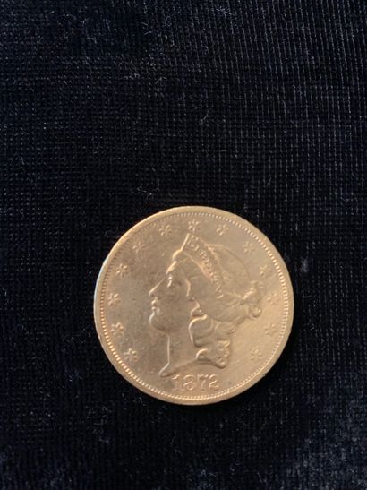 null Une pièce d'or de 20 dollars (1872). 
Poids : 33,37 gr.
(Usures)