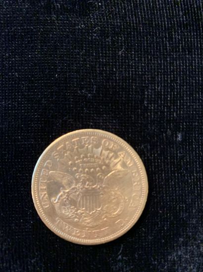 null Une pièce d'or de 20 dollars (1872). 
Poids : 33,37 gr.
(Usures)