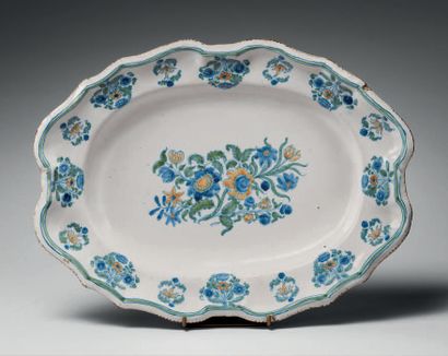 Moustiers Oval earthenware dish with contoured rim, polychrome decoration of bouquets...