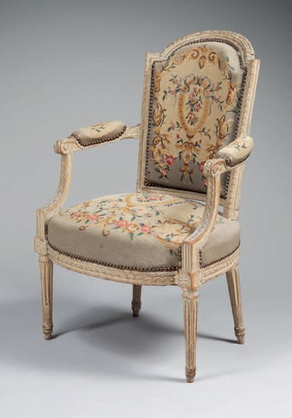 null Molded, carved and painted wooden armchair, with curved backrest, resting on...