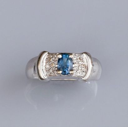   Bague en or gris 750°/00(18K), sertie d'un petit saphir ovale; épaulé de quatre...