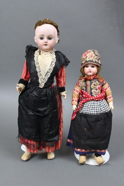 null Set of two regional dolls :

One, fixed head and porcelain collar marked in...