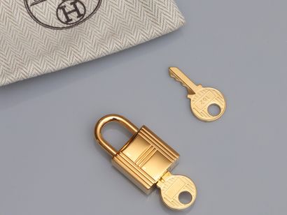 null HERMES, gold-plated bag lock small model, with 23 keys. Model 120. Signed and...