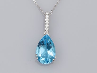 null 18K white gold link chain, and 18K white gold pendant, set with a pear cut blue...
