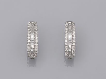 null Pair of creoles in 18K white gold, set with a row of baguette-cut diamonds between...