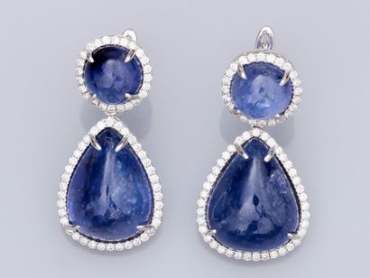 null Pair of 18K white gold earrings set with pear and round cabochon tanzanites...