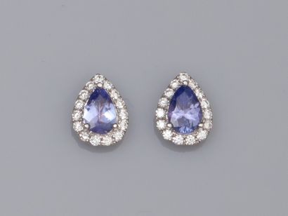 null Pair of 18K white gold earrings, each set with a pear tanzanite of about 0.40...