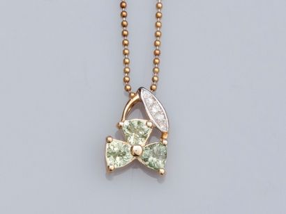 null Flower pendant in two-tone gold 375°/00, set with green sapphires and small...