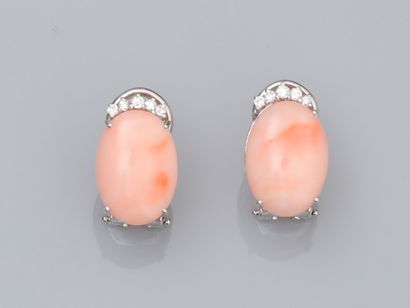 null Pair of 18K white gold earrings set with oval pink coral cabochons set with...
