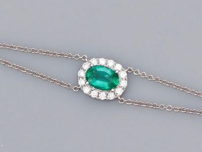 null Bracelet in 18K white gold, set with an oval emerald of about 0.60 carat, surrounded...
