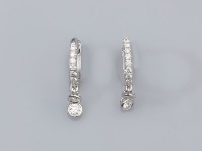 null Pair of earrings in 18K white gold, set with a line of small diamonds and holding...