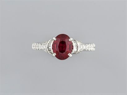 null Ring in 18K white gold, set with an oval ruby weighing 1.62 ct, with baguette...