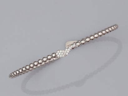 null Rigid open bracelet in 18K white gold, formed of small gold balls and centered...