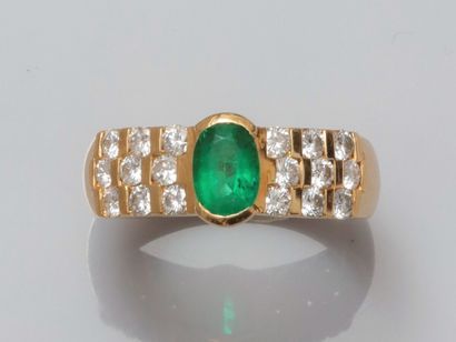 null Yellow gold ring 750°/°° (18K), set with an oval emerald of about 0.75 ct, with...