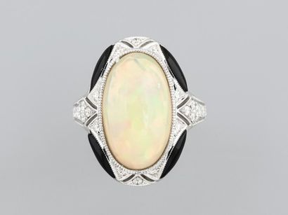 null Oval ring in 18K white gold, set with a cabochon opal weighing approximately...
