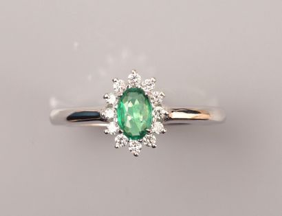 null Ring in 18K white gold, set with a small oval emerald weighing approximately...