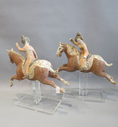 null Pair of polo players riding their mount in a jump. 

Terra cotta with engobe...