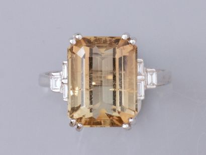 null Ring in 18K white gold, set with a rectangular yellow tourmaline weighing approximately...