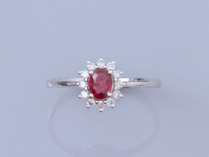 null Ring in 18K white gold, set with an oval faceted ruby weighing approximately...