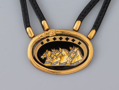 null HERMES, necklace with double strand of black leather, oval gilded pattern with...