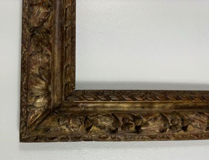 null Wooden frame carved with leaves and fruits motives, with gilding of the period...