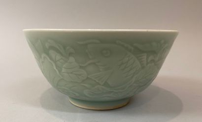null CHINA. Celadon green porcelain bowl decorated in light relief with fish and...