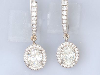 Pair of 18K white gold sleeper earrings,...