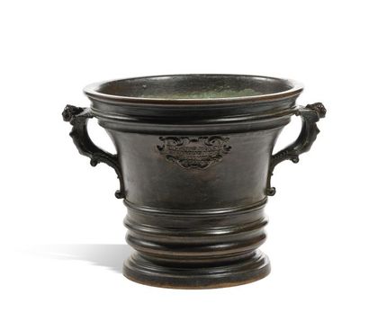  Bronze mortar with a brown patina and a flared shape, the body with ringed decoration...