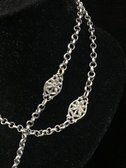  Long necklace in metal with round meshes and shuttles with filigree flower decoration....