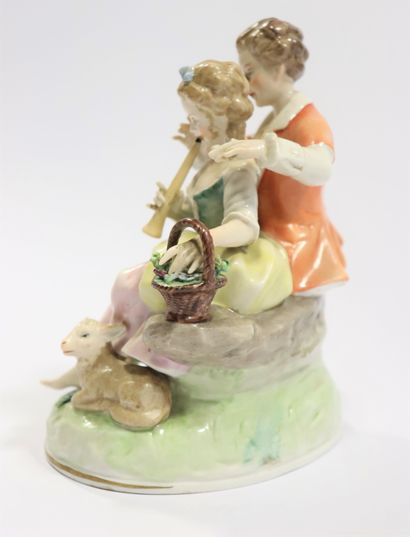  CAPODIMONTE 
Porcelain group representing a pastoral scene with a young couple playing...