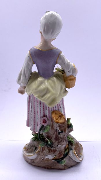  Germany, 19th century 
Small peasant woman with a basket of flowers in enameled...